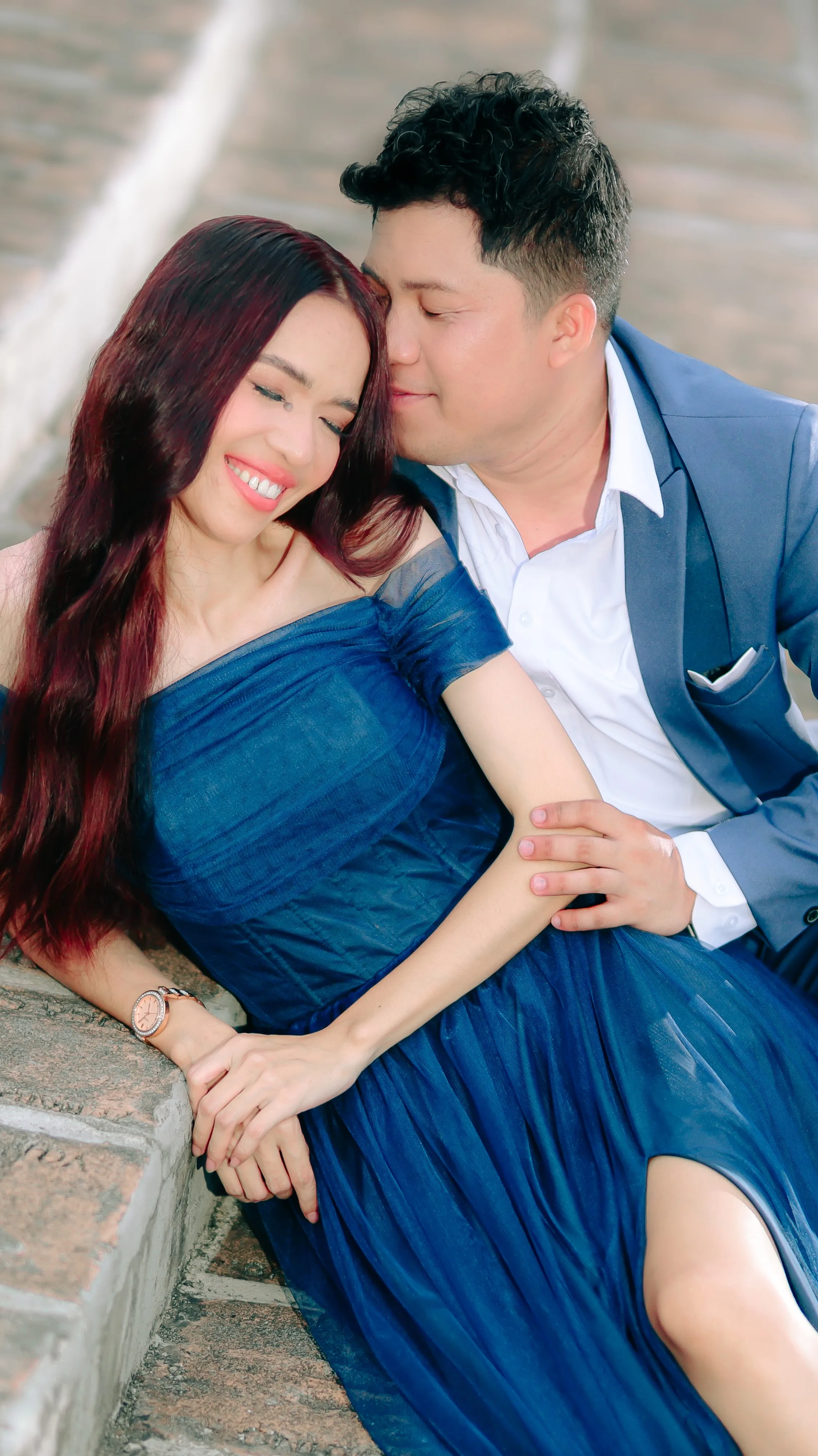 Jas smiling as Cid leans in close