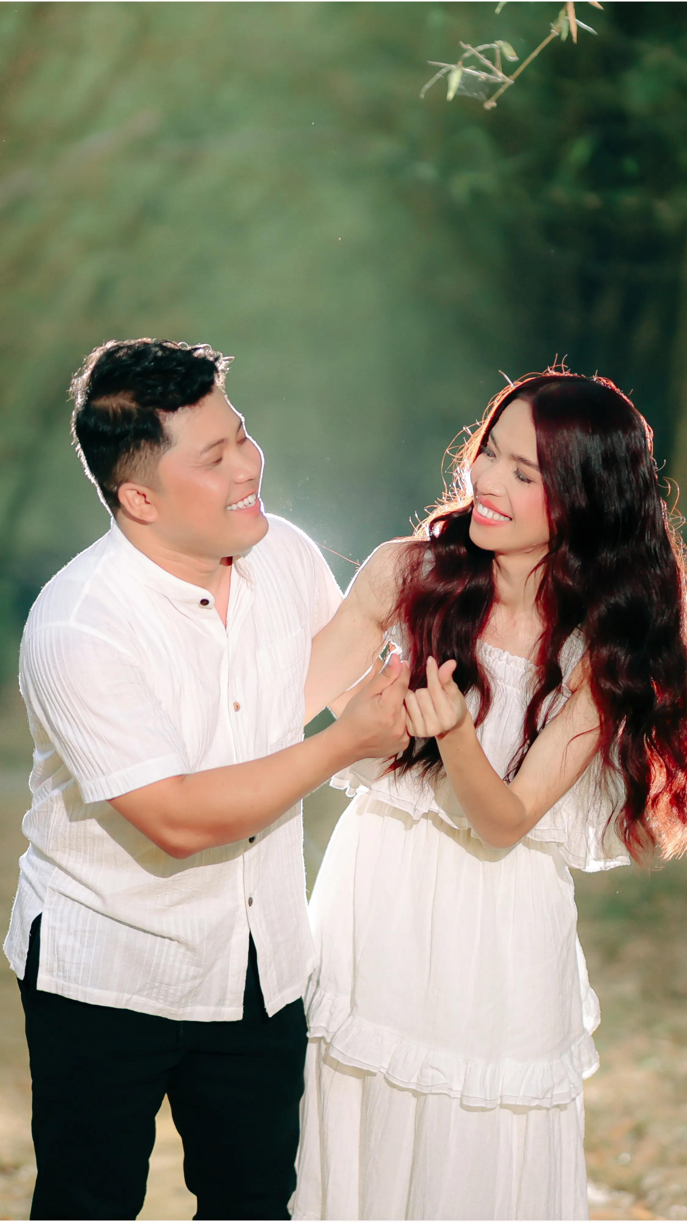 Cid and Jas laughing together, dressed in white